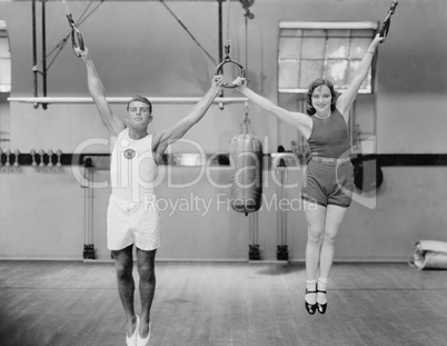 Athletes on rings in gym