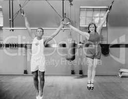 Athletes on rings in gym
