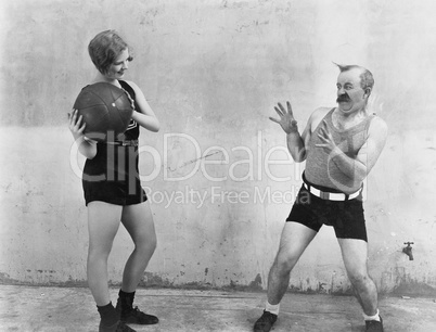 Woman throwing ball to nervous man