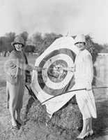 Women with bulls eye in archery target
