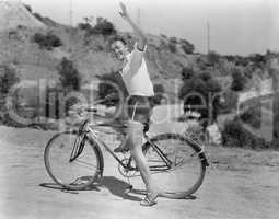 Male bicyclist waving