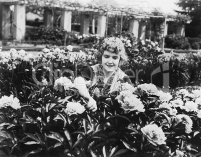 Woman tending flowers in garden