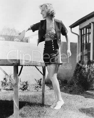 Woman playing ping pong outside