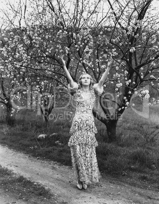 Woman with flowering trees