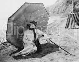 Woman with umbrella at beach