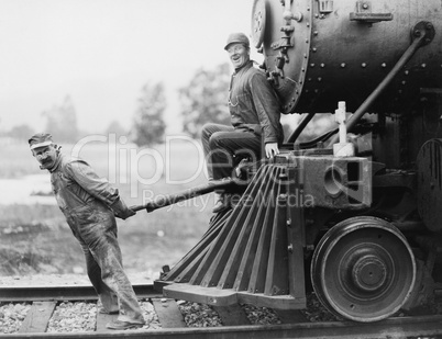 Engineers pulling train engine
