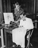 Young men using sewing machine
