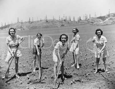 Portrait of women digging in field