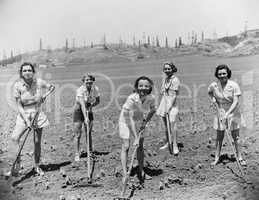 Portrait of women digging in field