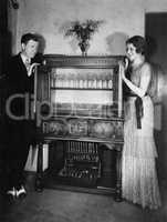 Proud couple with china cabinet