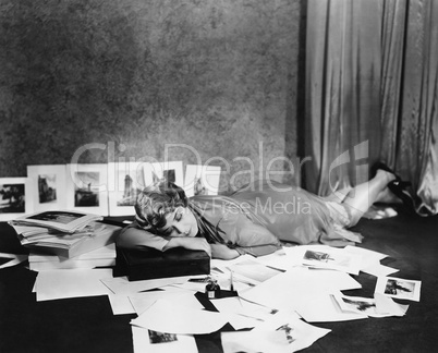 Woman asleep on floor surrounded by illustrations