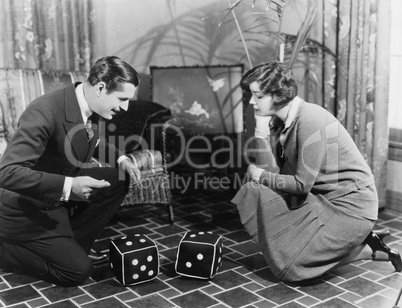 Couple playing with huge dice