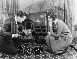 Couple playing with huge dice