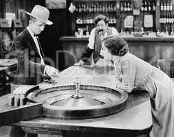 People at roulette table in bar