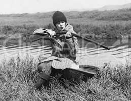 Female hunter with gun near river