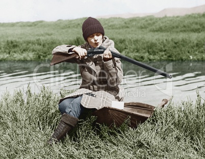 Female hunter with gun near river