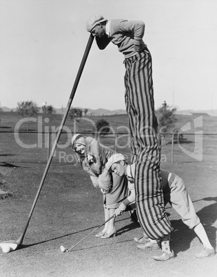 Golf game with man on stilts