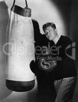Boxer using punching bag