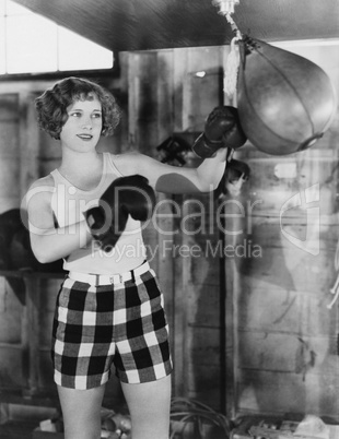 Female boxer using punching bag