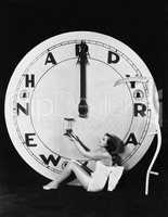 Woman with clock at midnight on New Years Eve