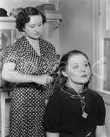 Woman styling another womans hair