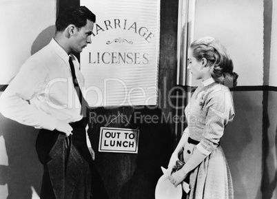 Couple waiting outside marriage license office