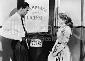 Couple waiting outside marriage license office