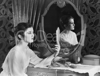 Woman looking in mirror