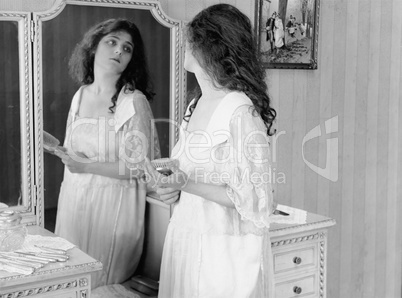 Woman looking in mirror