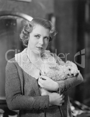 Woman holding tiny puppy