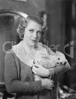 Woman holding tiny puppy
