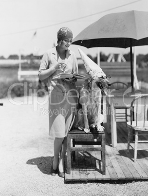 Woman with dog wearing hat and glasses