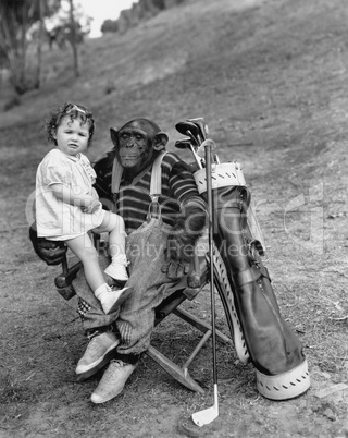 Monkey with golf clubs and toddler girl