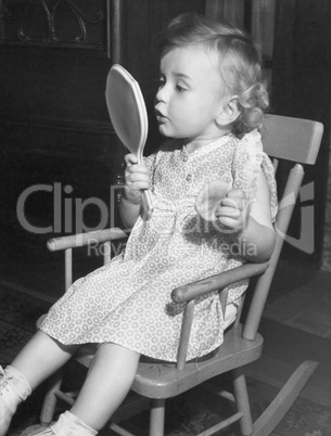 Little girl looking in mirror