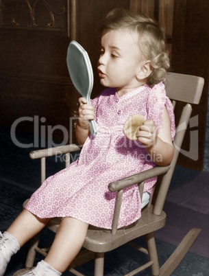 Little girl looking in mirror
