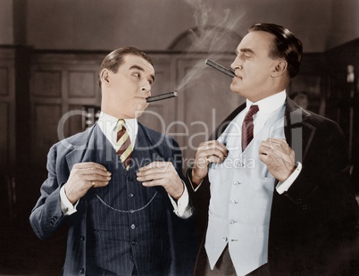 Two men smoking cigars