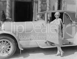 Portrait of woman posing with car