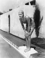 Female swimmer at edge of pool