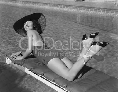 Woman sunbathing at pool