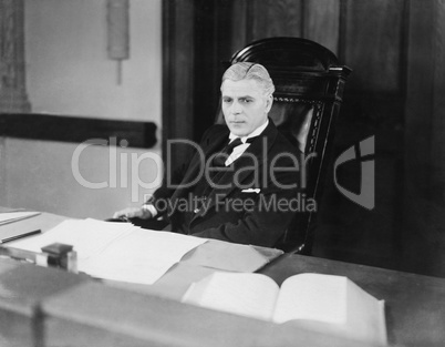 Serious man sitting at desk