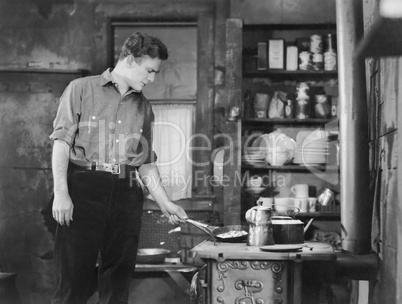 Man cooking on woodstove