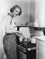 Portrait of woman cooking at stove