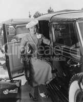 Woman with car and luggage