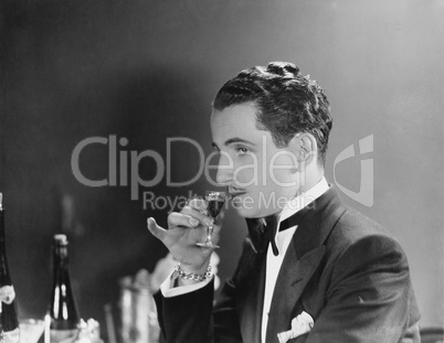 Man drinking glass of liqueur