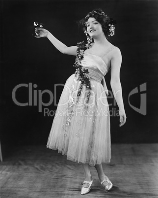 Portrait of woman toasting with glass