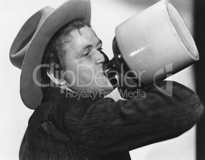 Portrait of man drinking from jug