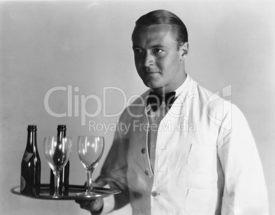 Waiter with beverages on tray