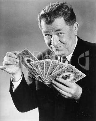 Portrait of man with large cards