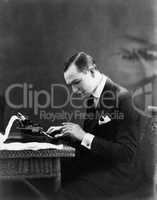 Portrait of man using typewriter
