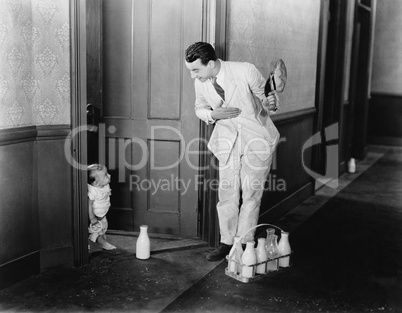 Milkman greeting baby at door